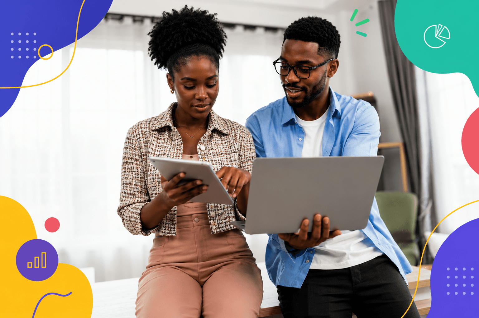 Two business partners review an invoice together on a tablet and laptop